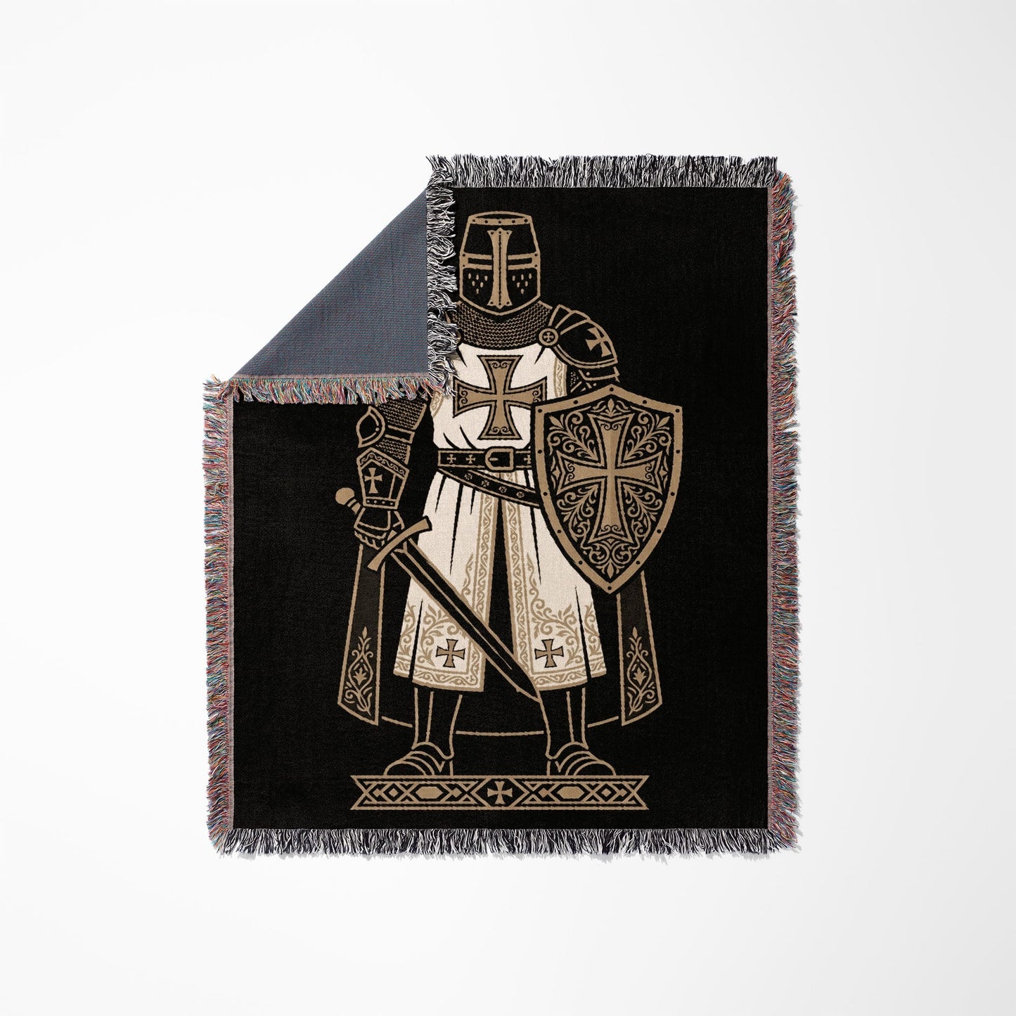 Knight in armor with sword and shield on black blanket.