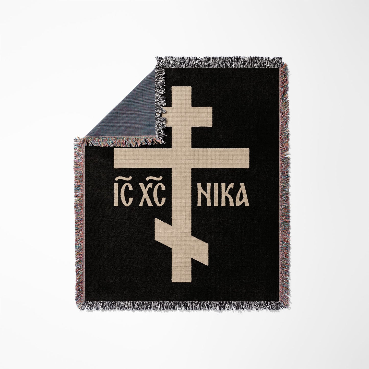 Black throw blanket with tan Greek Orthodox cross and text "IC XC NIKA".