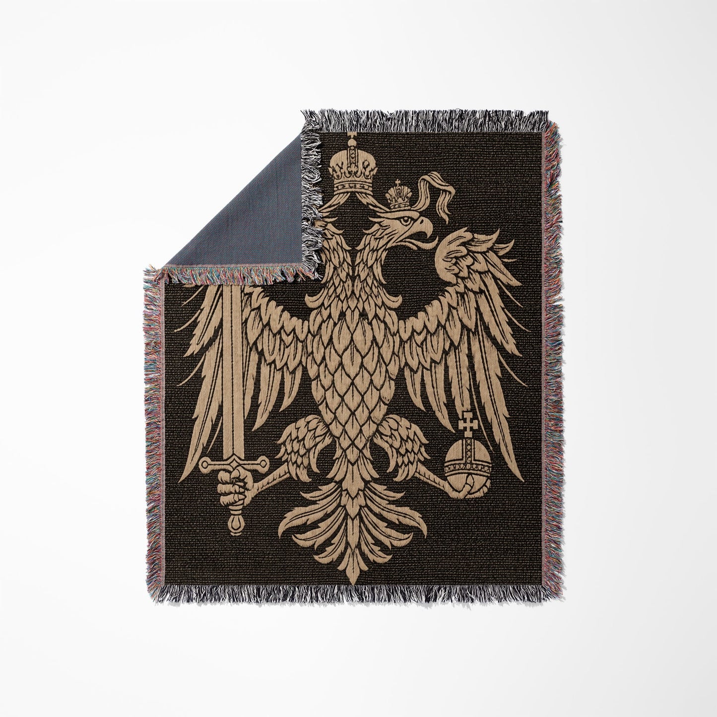 Golden double-headed eagle crest with crown, sword, and orb on a dark woven blanket.