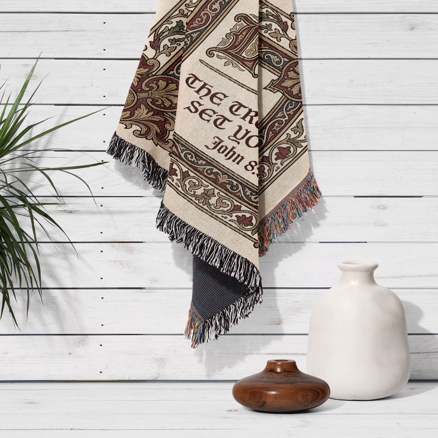Woven tapestry with "The truth will set you free" text, fringed edges, hanging on wall.