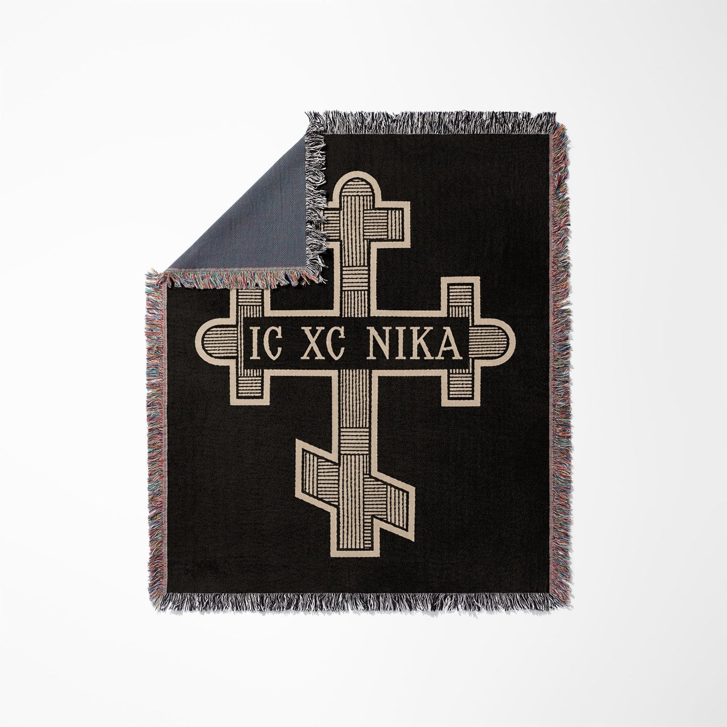 Black woven blanket with Orthodox cross and text "IC XC NIKA" and fringe.