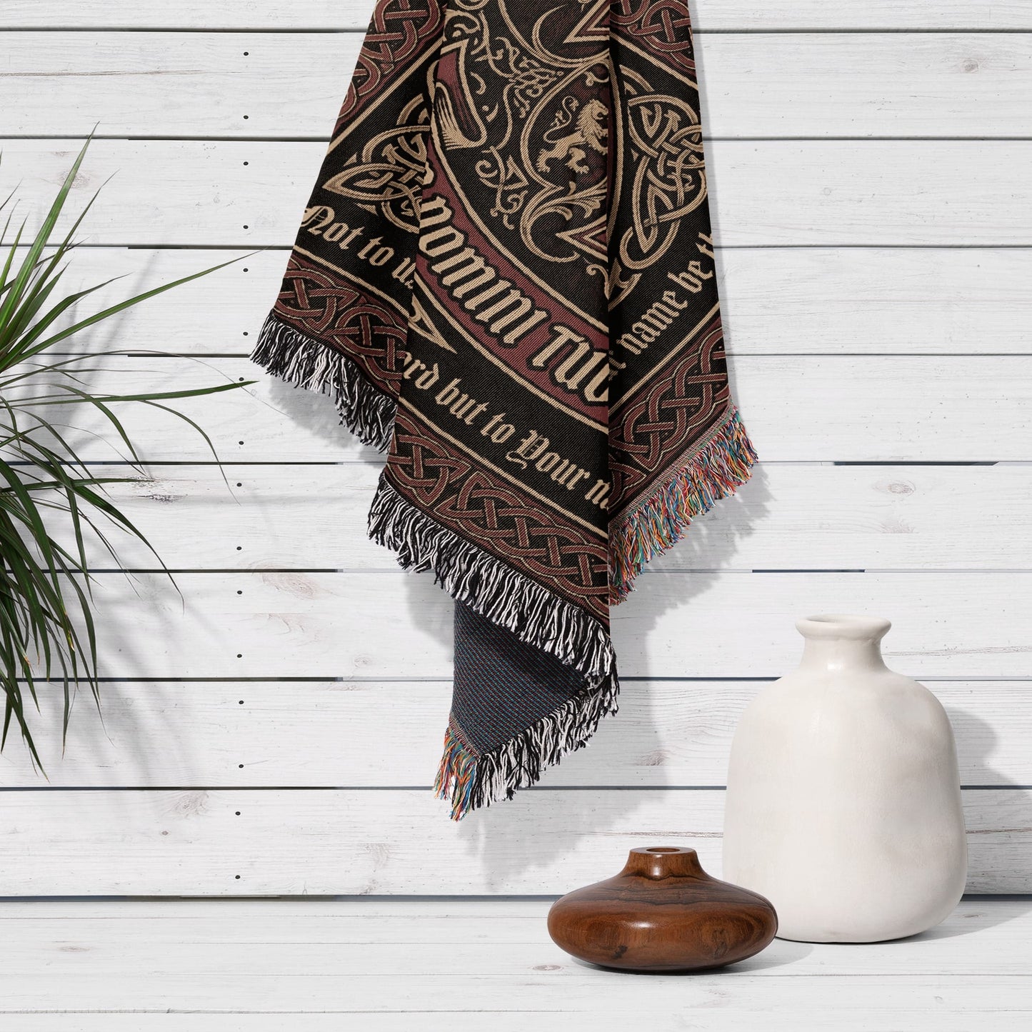 Tapestry with Celtic knotwork and text "Domini Tui" hanging on a white wall.