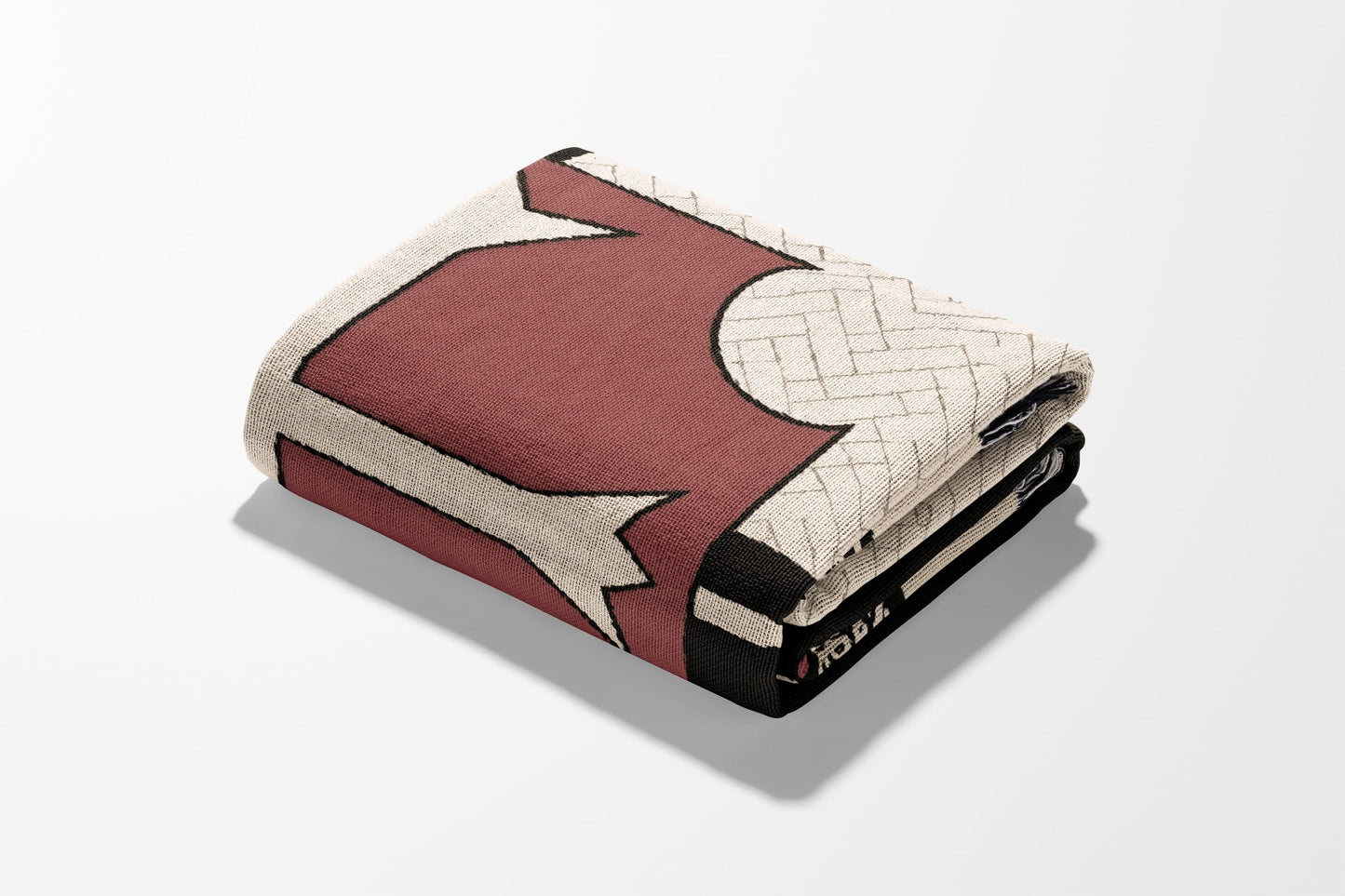 Folded burgundy and cream patterned blanket with a detailed edge.