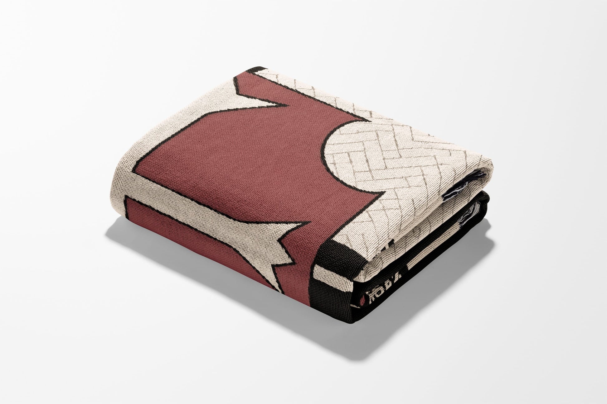 Folded burgundy and cream patterned blanket with a detailed edge.