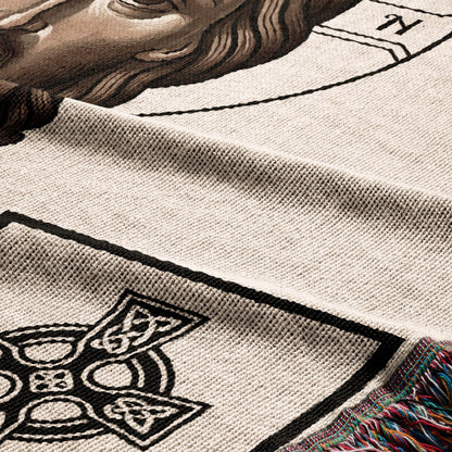Cream knit blanket with Celtic knot detail and colorful fringe.