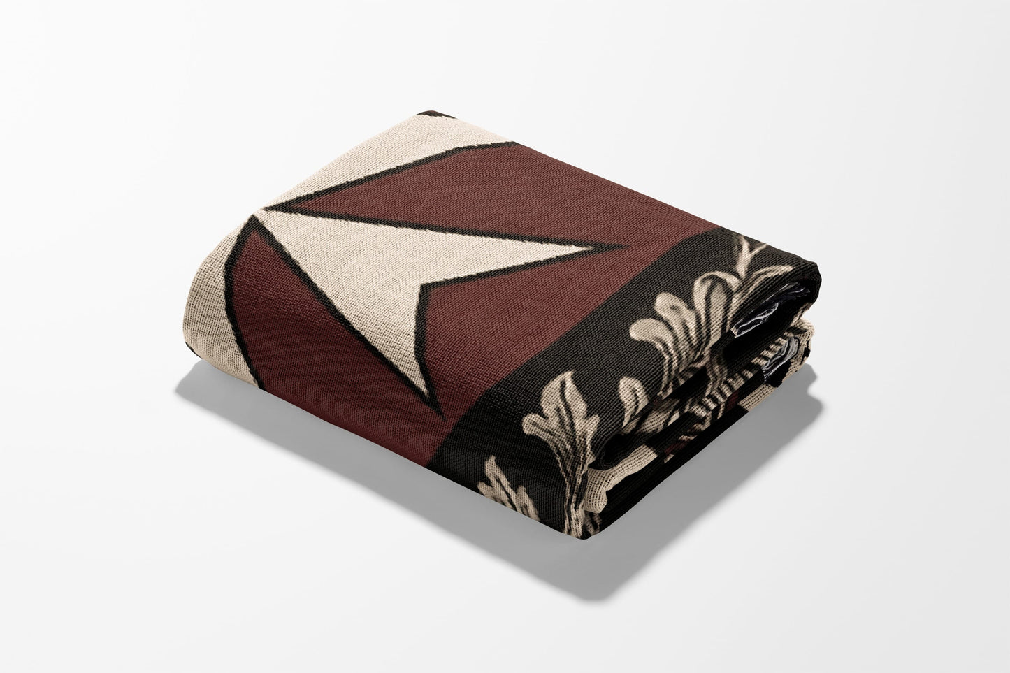 Rolled blanket with geometric and floral patterns in brown and cream.