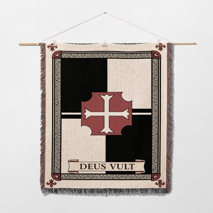 Woven tapestry with a red cross on a quartered black and white background, featuring "Deus Vult" text.