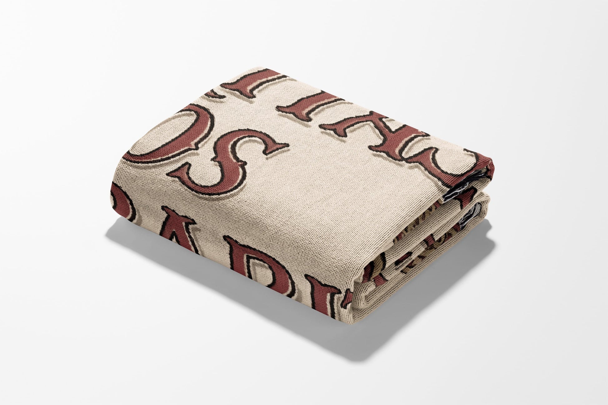 Folded blanket with "LOVED" text in maroon cursive lettering.