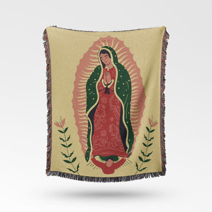 Woven blanket with a depiction of the Virgin of Guadalupe on a pale yellow background.