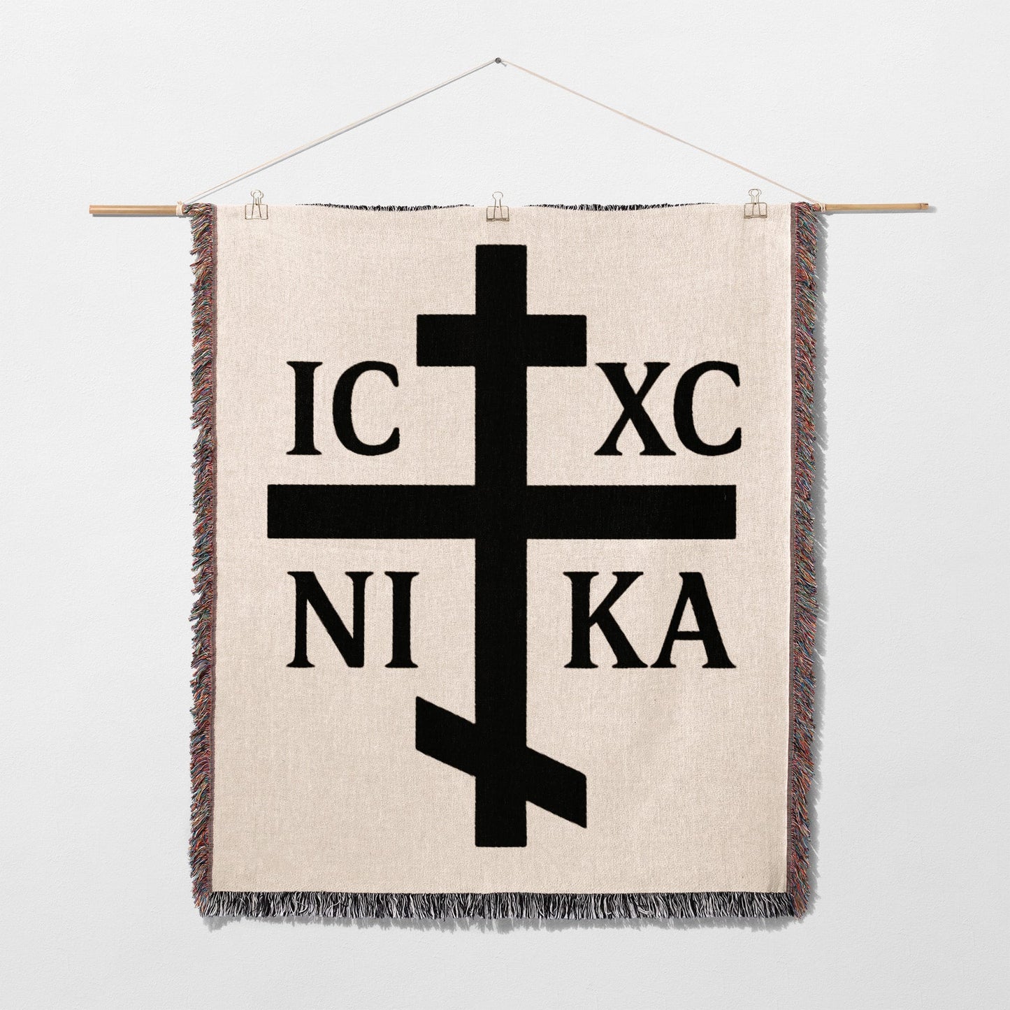 Orthodox cross with IC XC NI KA text on a woven tapestry.