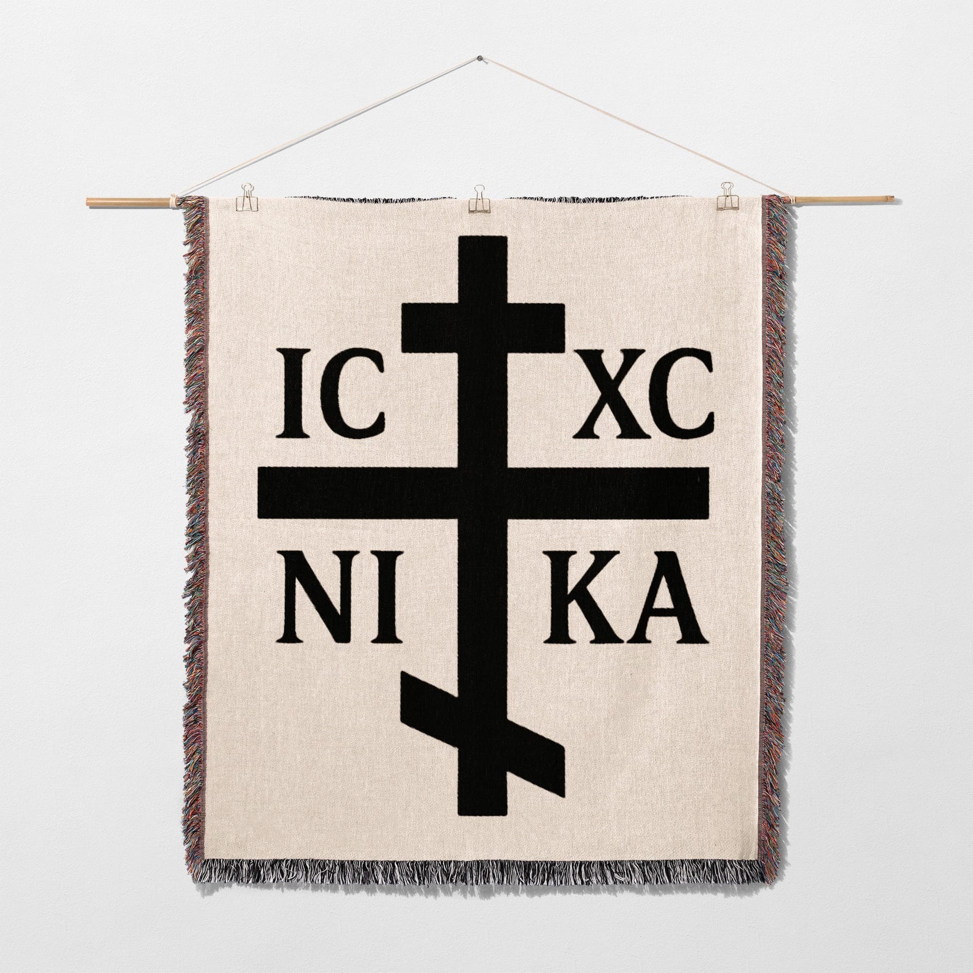 Orthodox cross with IC XC NI KA text on a woven tapestry.