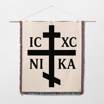 Orthodox cross with IC XC NI KA text on a woven tapestry.