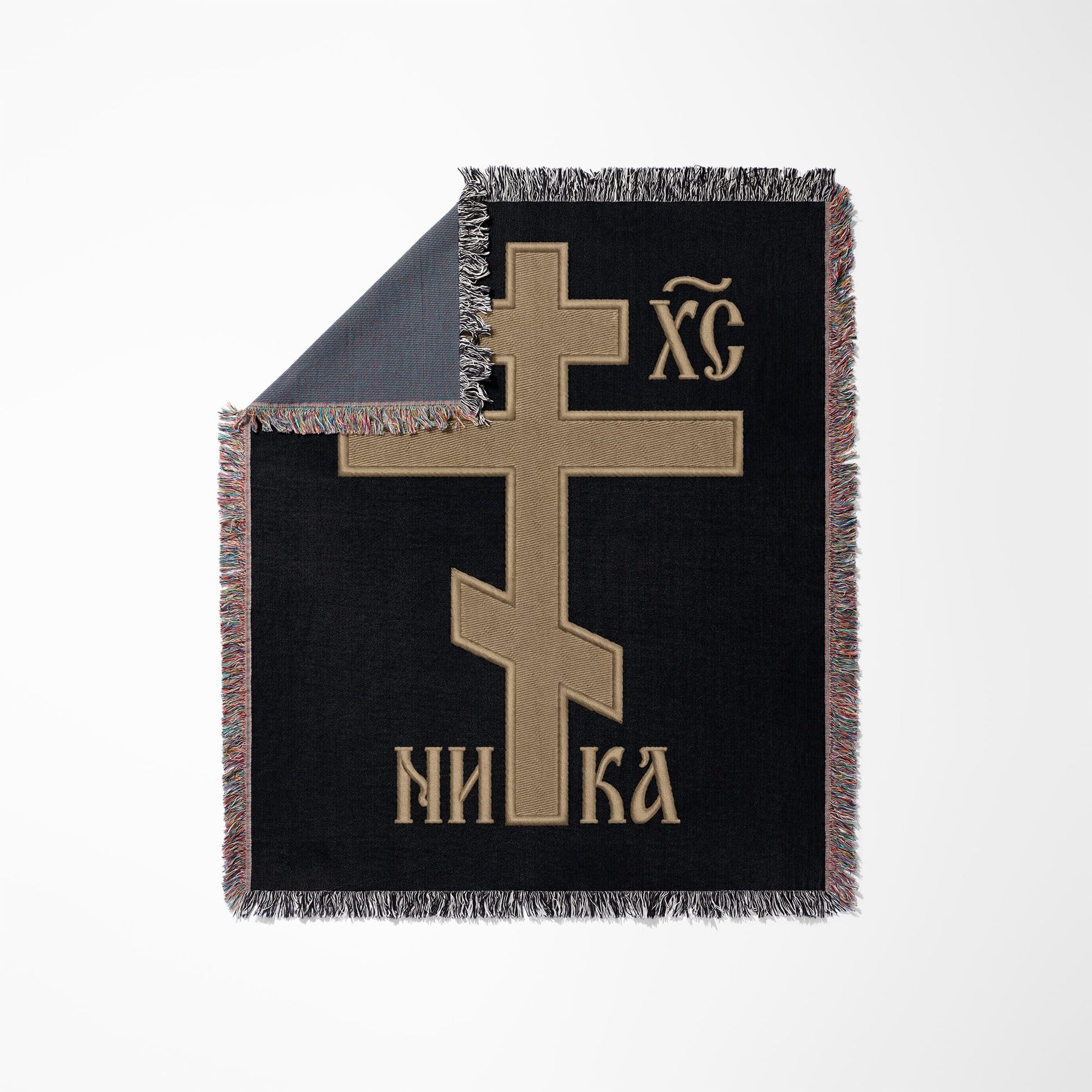 Black blanket with tan Eastern Orthodox cross and text.