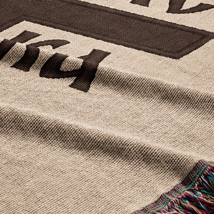 Woven throw blanket with a large dark brown "14" design and colorful fringe.