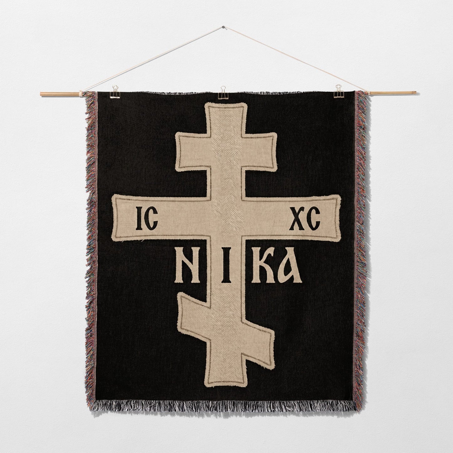 Black tapestry with a gold Orthodox cross and IC XC NIKA inscription.