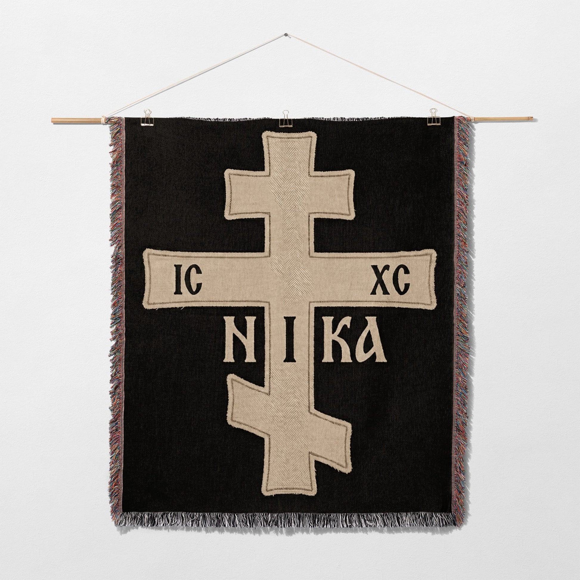 Black tapestry with a gold Orthodox cross and IC XC NIKA inscription.