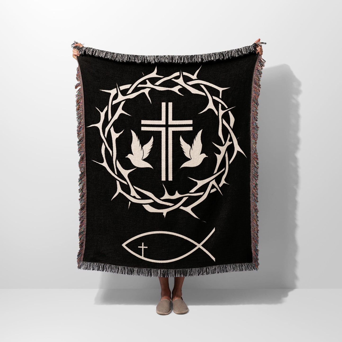 Black blanket with crown of thorns, dove, and fish symbols.