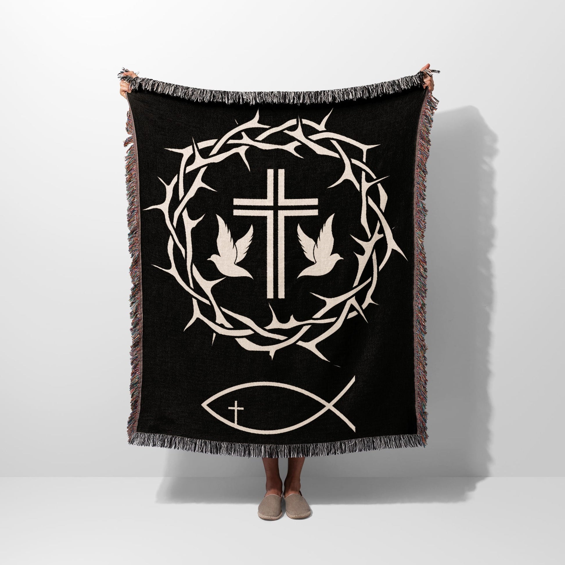 Black blanket with crown of thorns, dove, and fish symbols.
