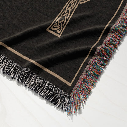 Black throw blanket with a Celtic knot design and fringed edges.