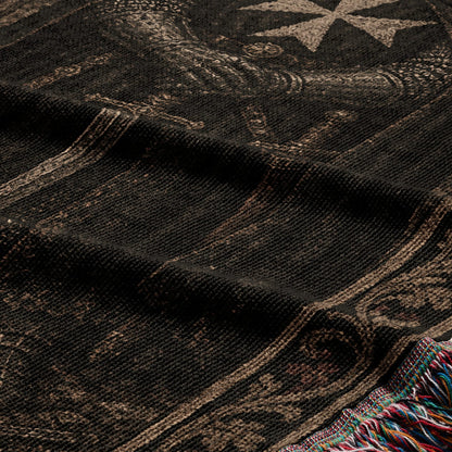 Black woven fabric with intricate tan pattern and fringed edge.