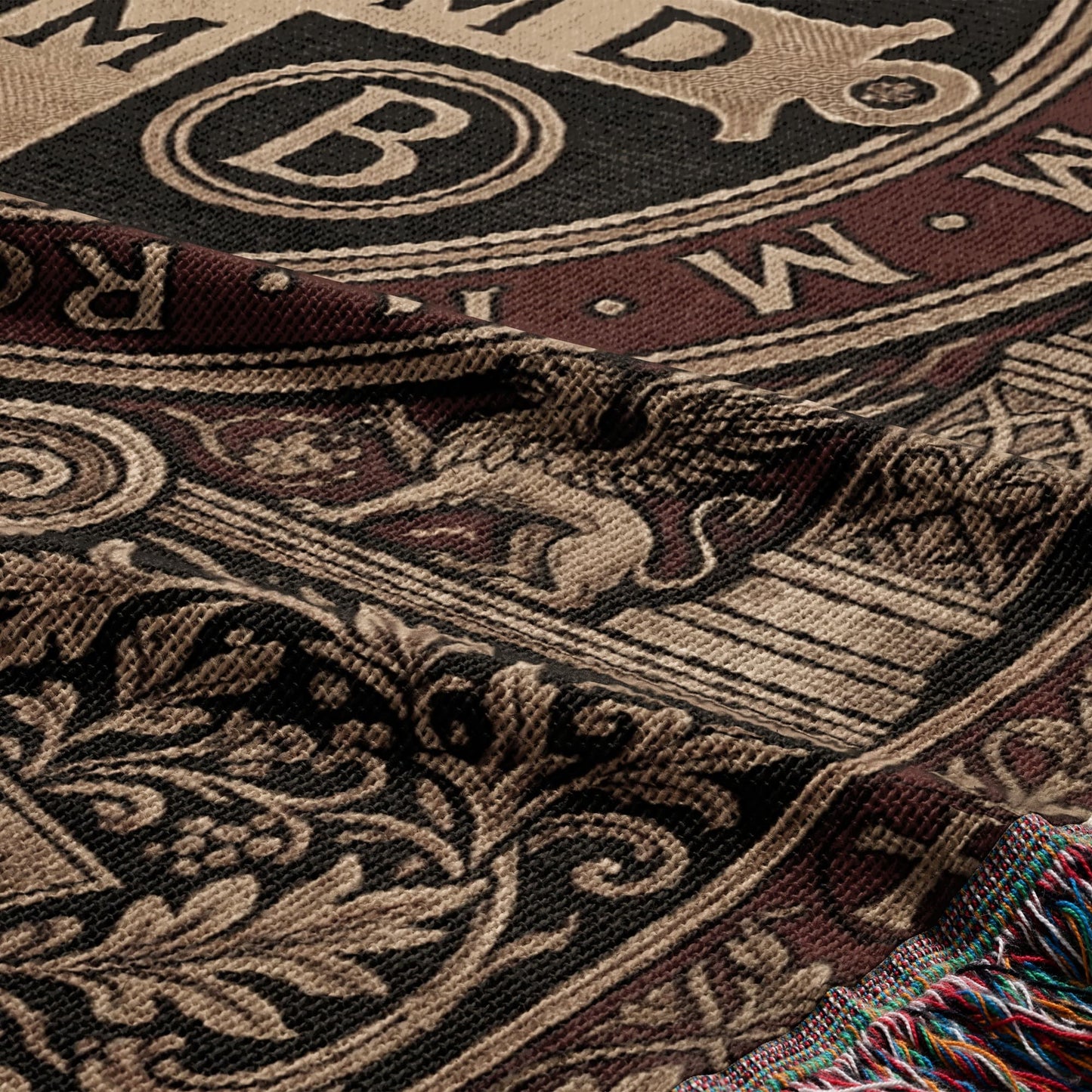 Tapestry blanket with ornate design, featuring a large letter B and a lion motif.