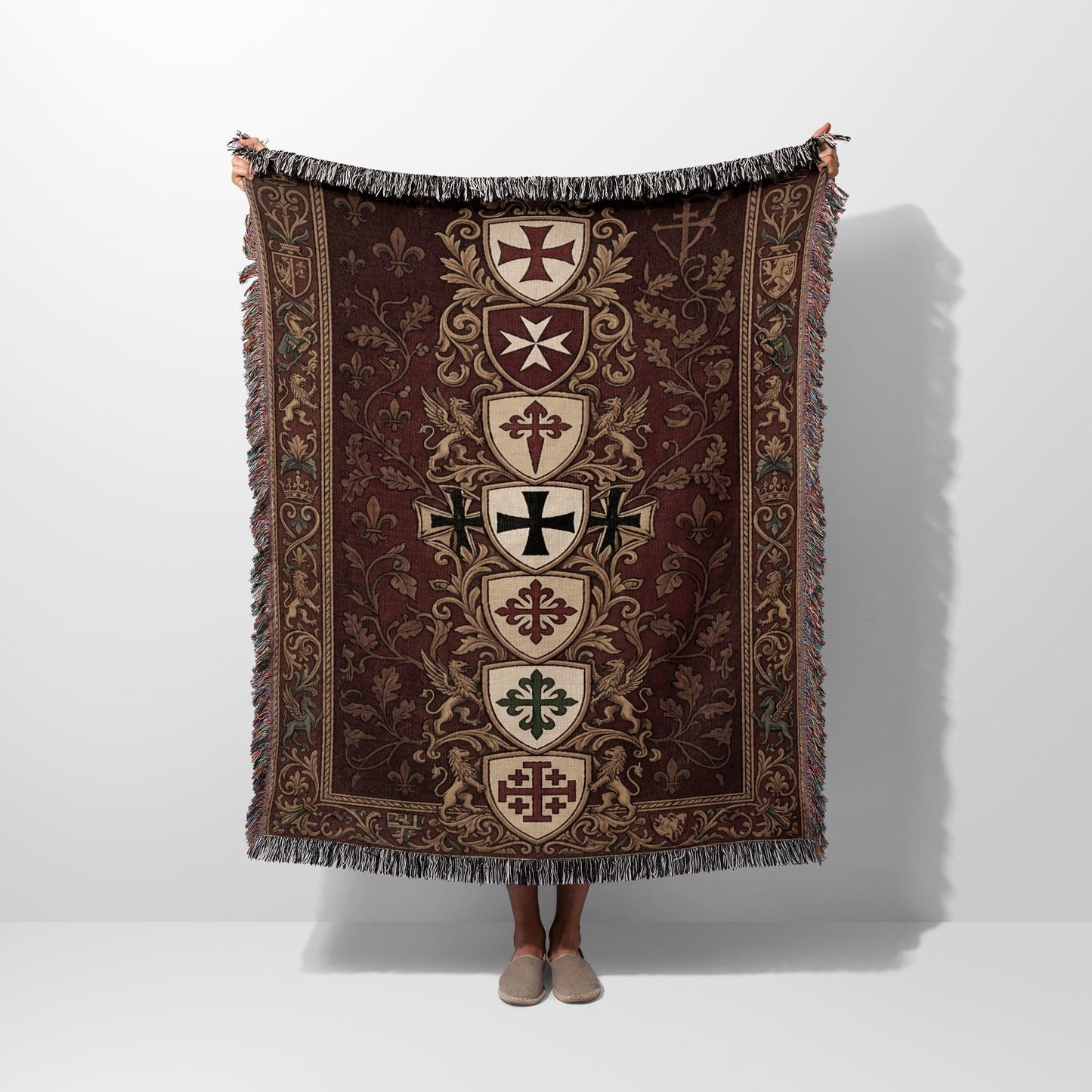Tapestry blanket with a medieval crests and fleur-de-lis pattern.