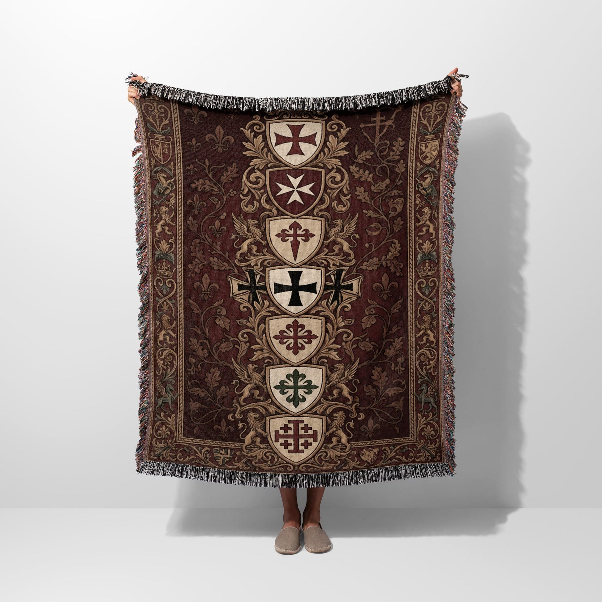 Tapestry blanket with a medieval crests and fleur-de-lis pattern.