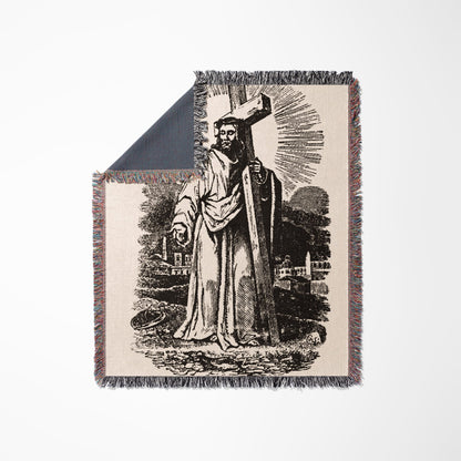 Black and white depiction of Jesus carrying a cross on a blanket.