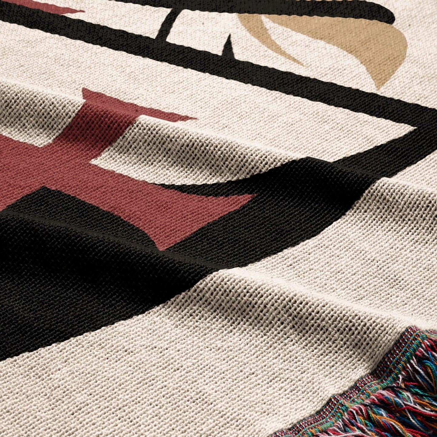 Cream blanket with red and black templar cross pattern and fringed edge.