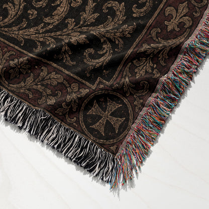 Woven blanket with ornate dark brown damask pattern and fringe.
