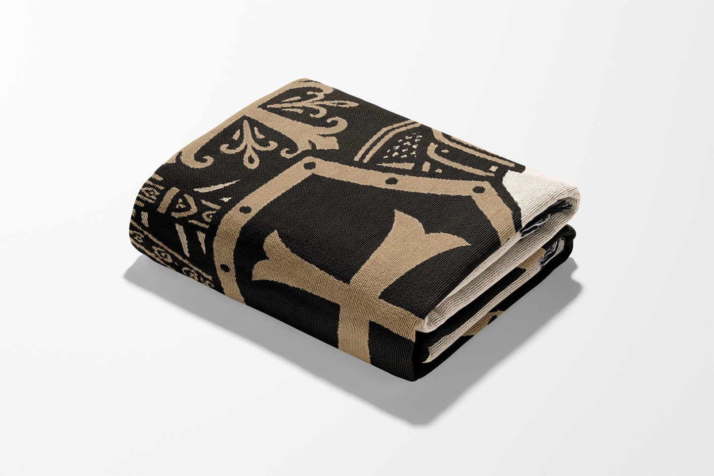 Black and tan folded blanket with ornate pattern and central "H" emblem.