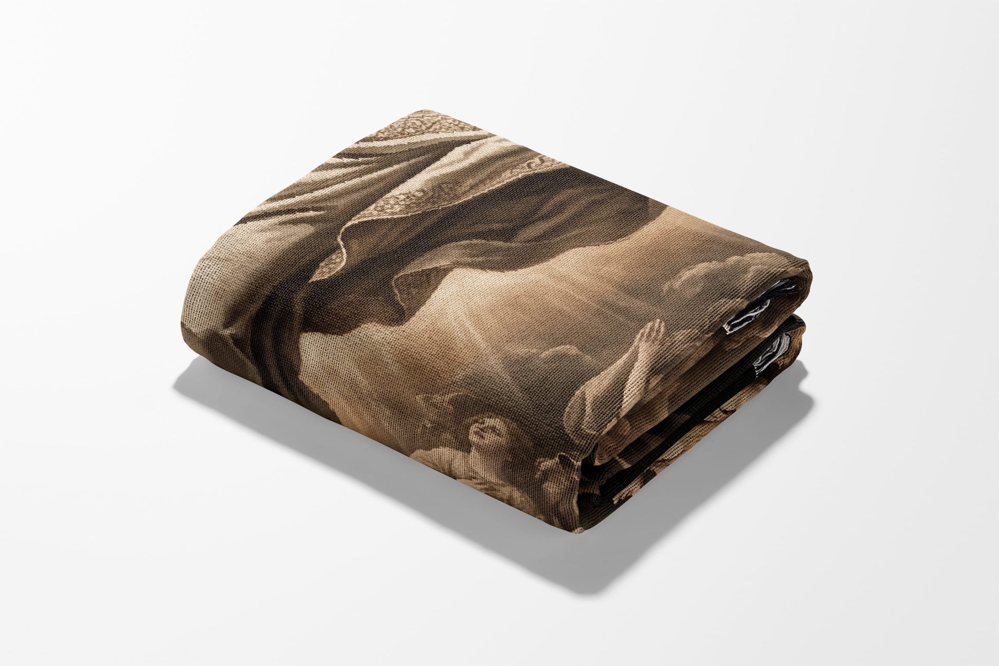 Folded blanket with religious artwork depicting a figure in flowing robes and clouds.
