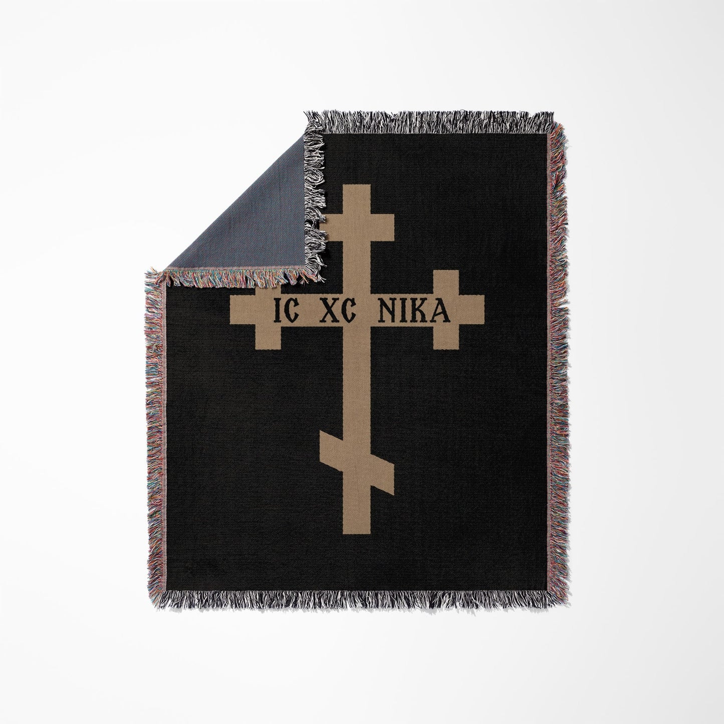 Black throw blanket with a tan Orthodox cross and "IC XC NIKA" text.