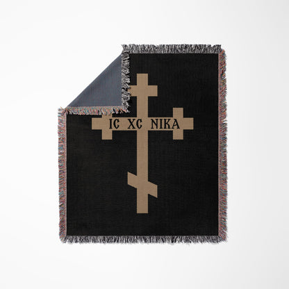 Black throw blanket with a tan Orthodox cross and "IC XC NIKA" text.