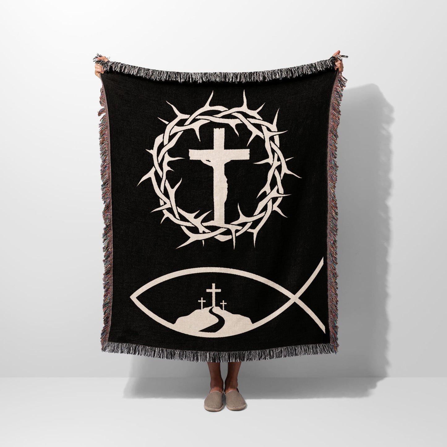Black blanket with a Jesus fish symbol, crown of thorns, and three crosses.