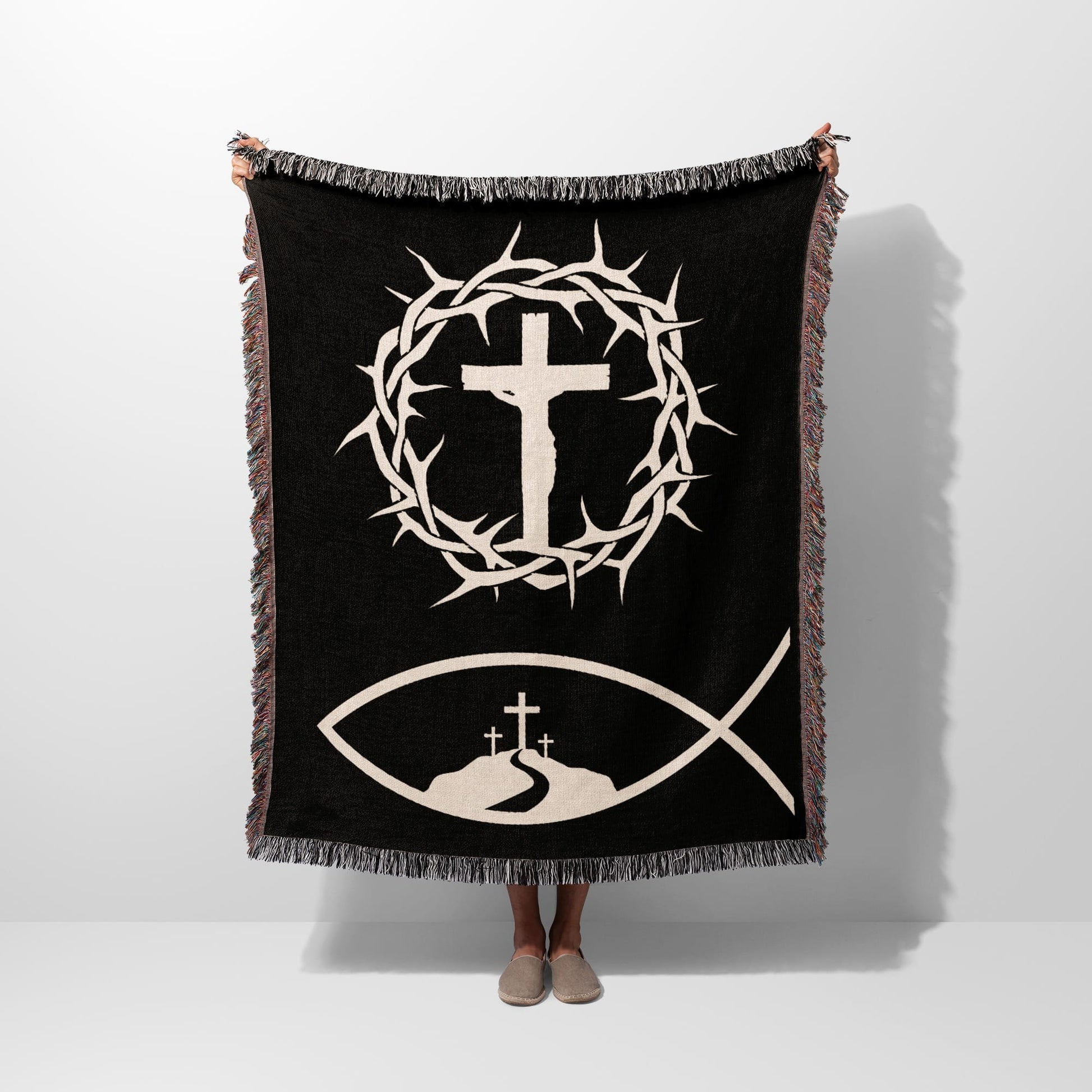 Black blanket with a Jesus fish symbol, crown of thorns, and three crosses.