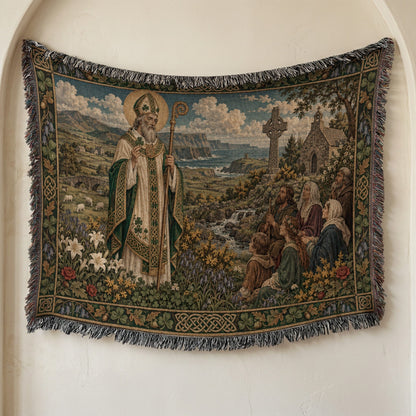 A woven tapestry hanging on a wall depicts Saint Patrick addressing a group of people near an Irish landscape.