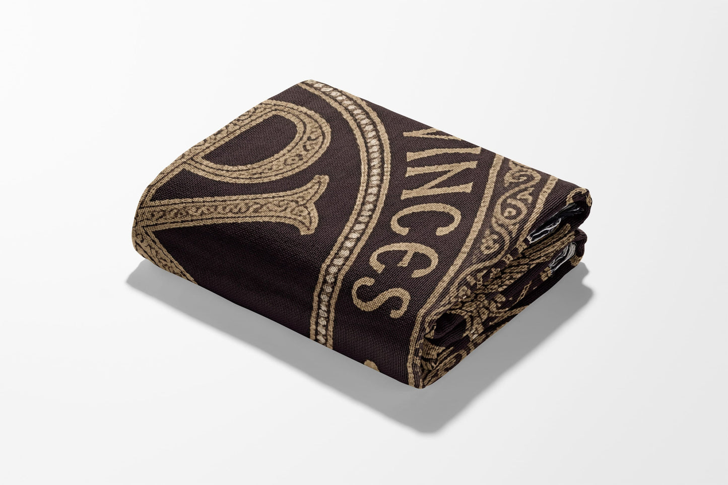 Rolled towel with gold "VINCE" text on a dark brown background.