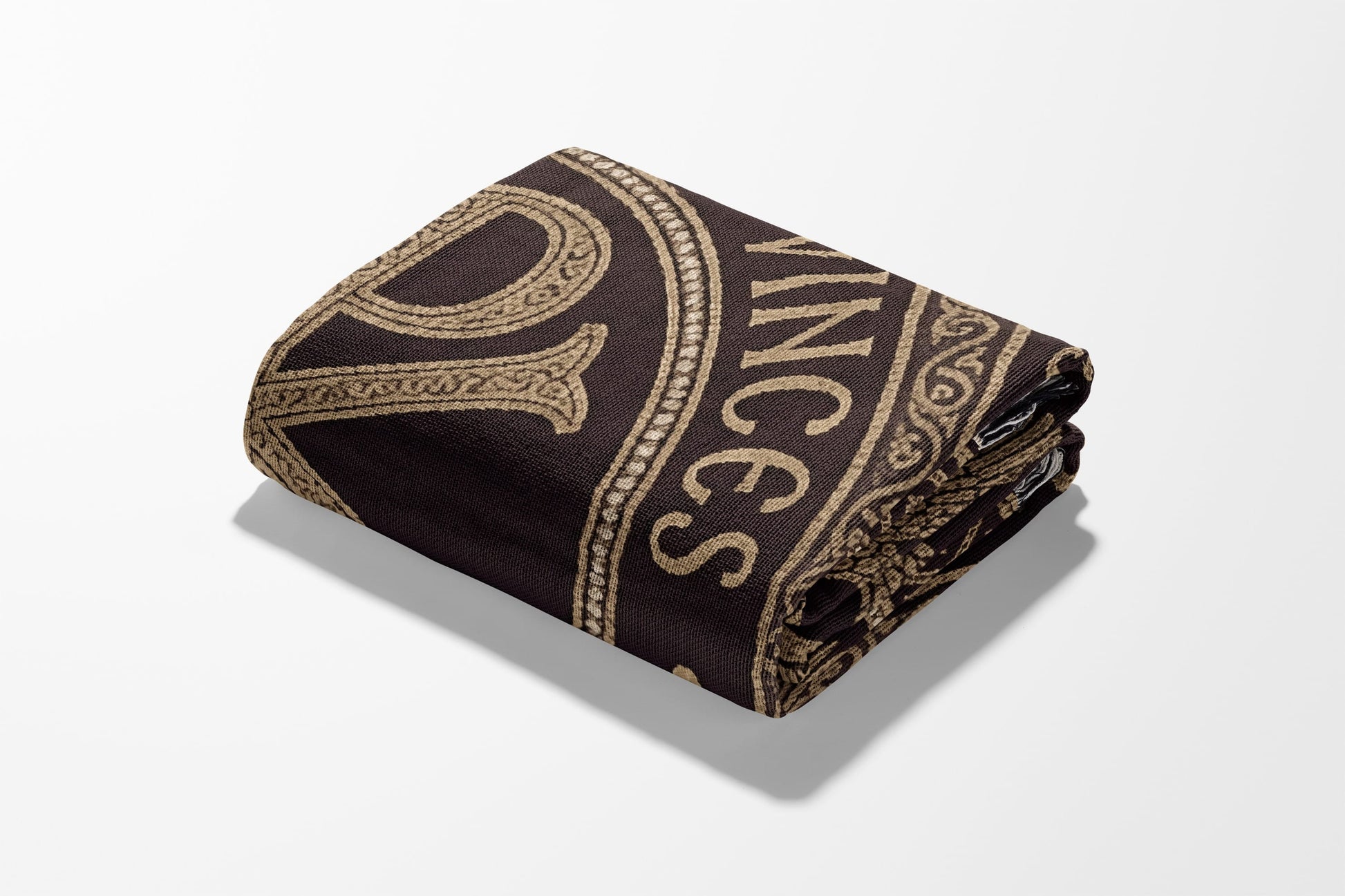 Rolled towel with gold "VINCE" text on a dark brown background.