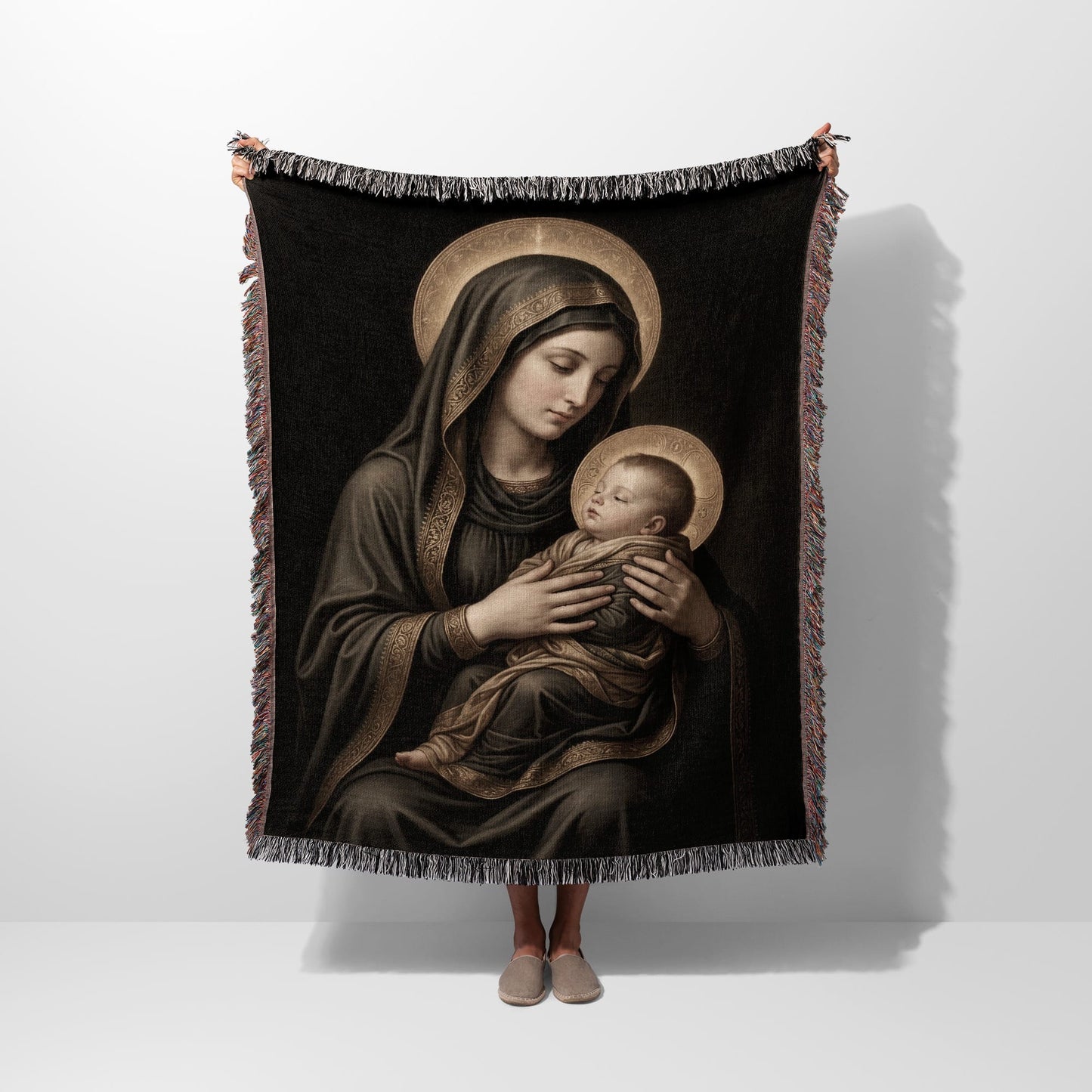 Religious tapestry featuring the Virgin Mary holding the baby Jesus with halos.