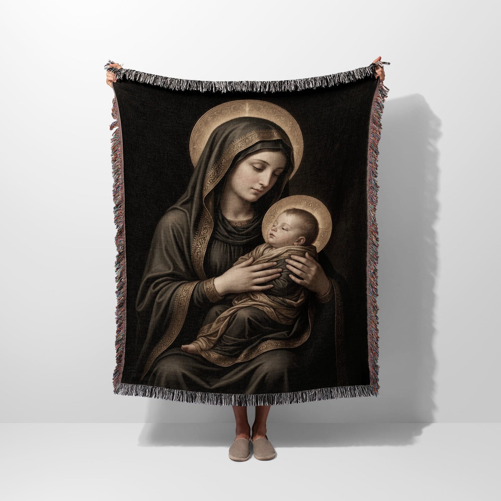 Religious tapestry featuring the Virgin Mary holding the baby Jesus with halos.