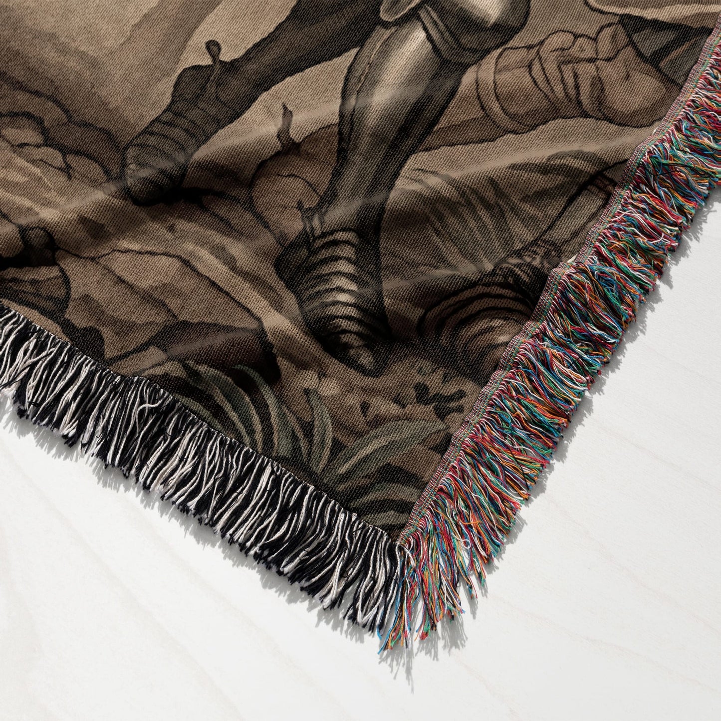 Woven blanket with fringe, depicting a mythological scene in muted tones.