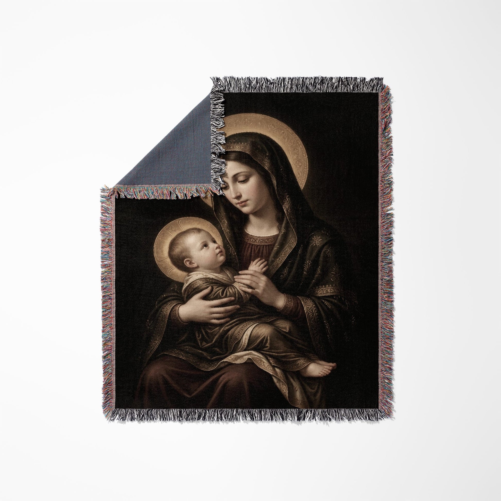 Madonna and Child painting on a fringed throw blanket.