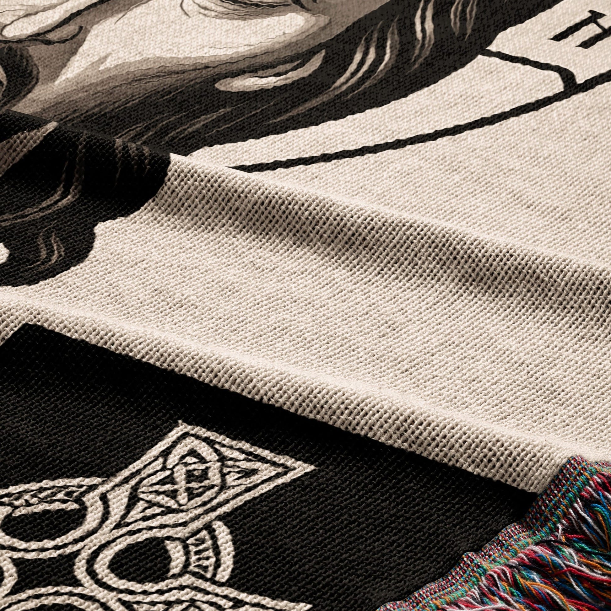 Woven throw with Celtic knot design and a partial portrait.