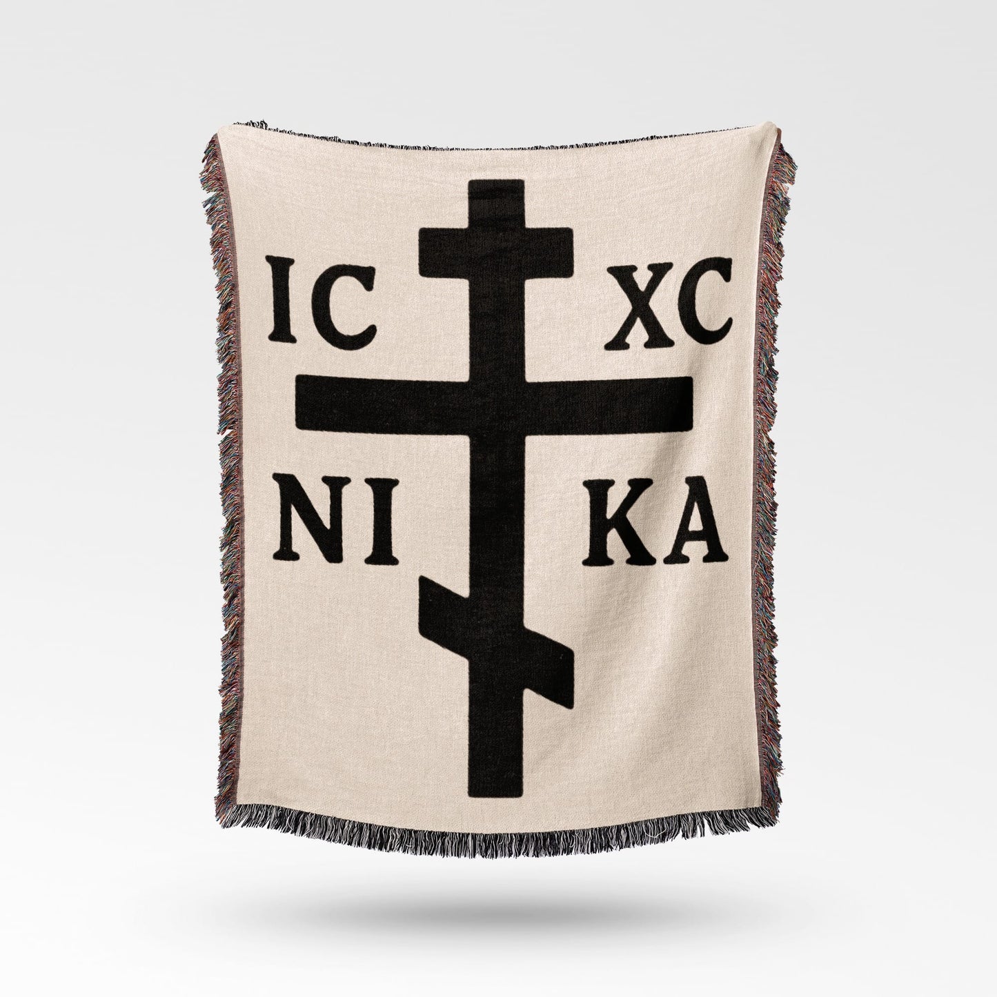Beige blanket with black Orthodox Christian cross and Greek lettering IC XC NI KA.