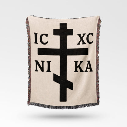 Beige blanket with black Orthodox Christian cross and Greek lettering IC XC NI KA.