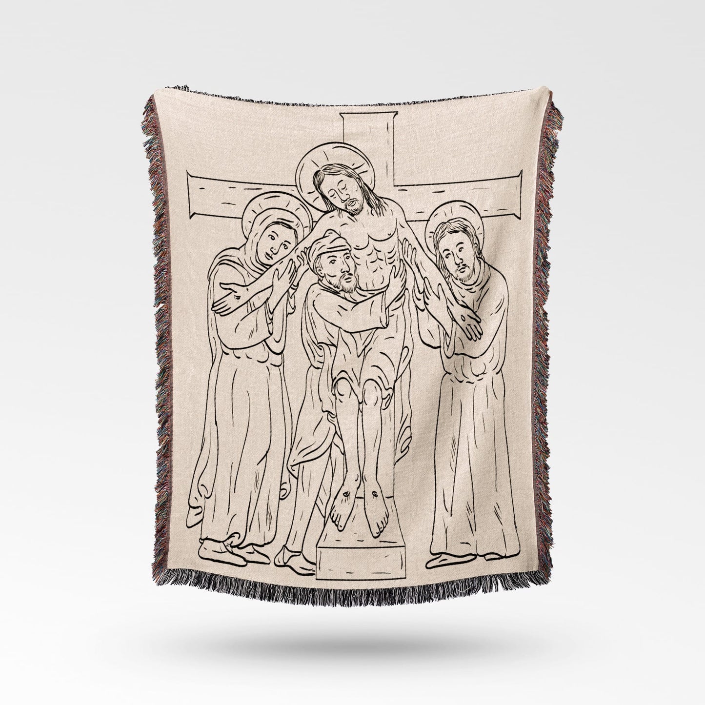 Jesus being taken down from the cross in line drawing on a woven blanket.