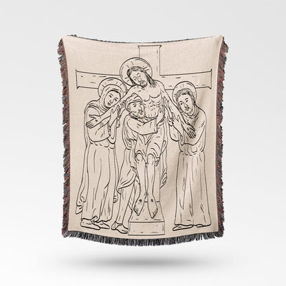 Jesus being taken down from the cross in line drawing on a woven blanket.