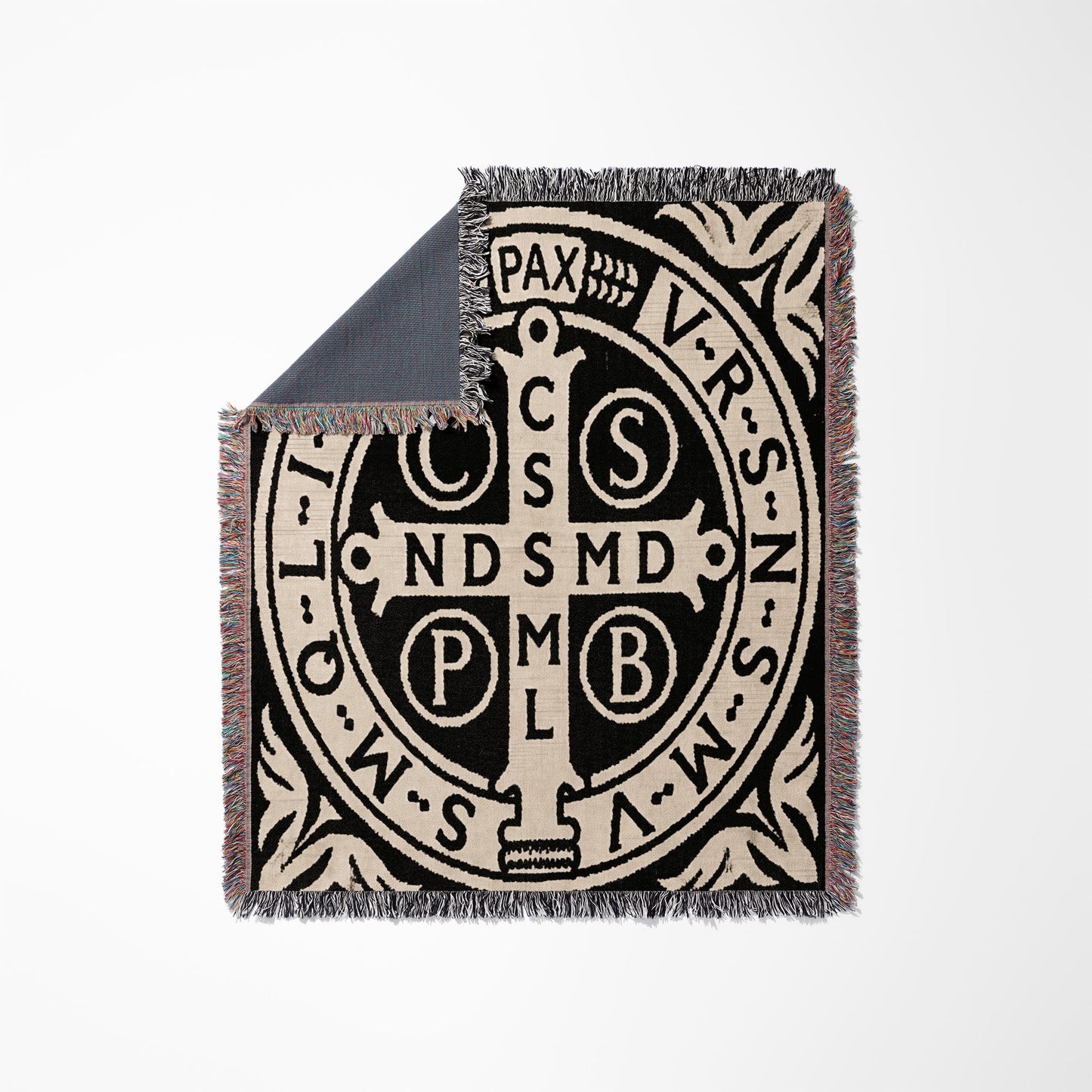 Black and cream Saint Benedict medal throw blanket with fringe and colorful threads.