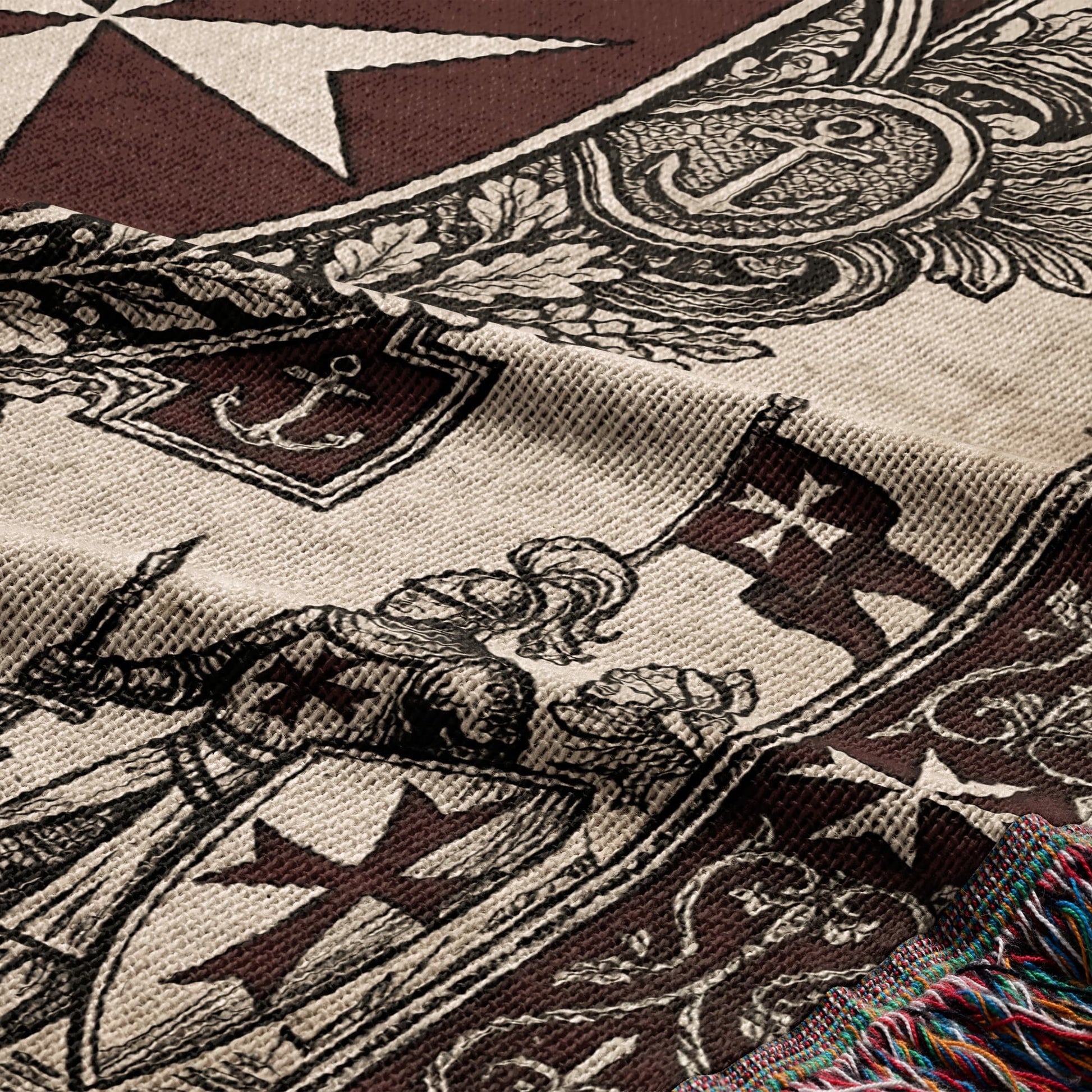 Woven blanket with knight, flags, anchors, and crosses in brown and cream.